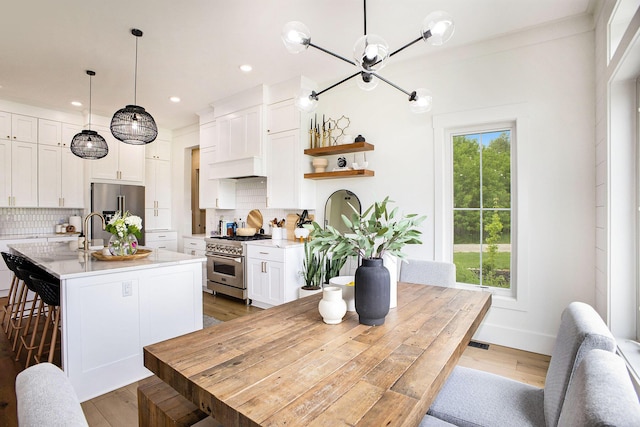 2958 S Edgar Rd, Mason, MI 48854 - dining area with healthy amount of natural light, light wood-style flooring, recessed lighting, and a chandelier