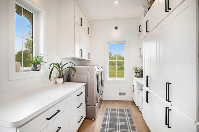 2958 S Edgar Rd, Mason, MI 48854 - washroom featuring washer and dryer, cabinet space, light wood-style floors, recessed lighting, and baseboards