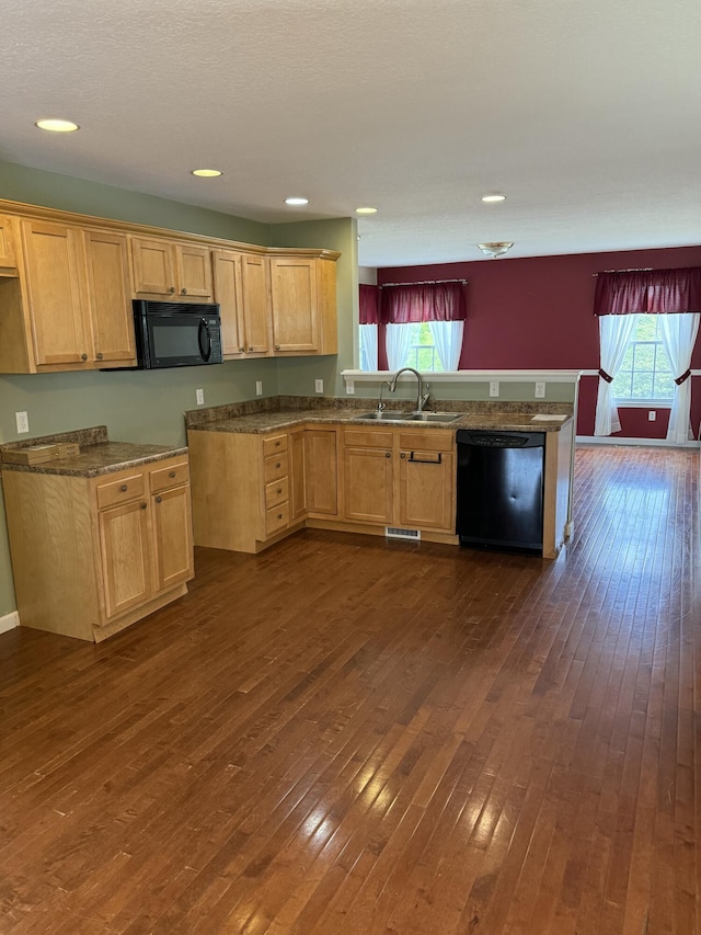 12 Picardy Pl, Hillsdale, MI 49242 - kitchen featuring black appliances, a peninsula, dark wood-style flooring, a sink, and recessed lighting