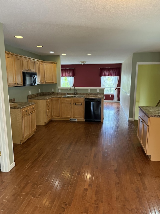12 Picardy Pl, Hillsdale, MI 49242 - kitchen featuring black appliances, a sink, a peninsula, dark wood-type flooring, and baseboards