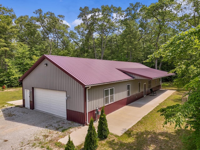 1304 Michillinda Rd, Muskegon, MI 49445 - view of front of home featuring a garage, metal roof, and driveway