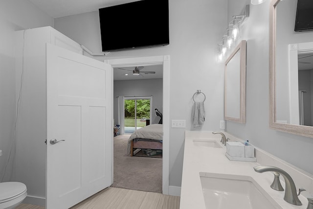 1304 Michillinda Rd, Muskegon, MI 49445 - full bathroom featuring double vanity, ensuite bathroom, toilet, and a ceiling fan