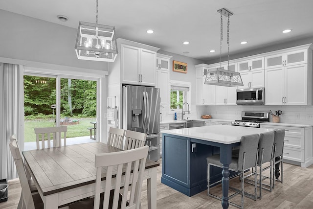 1304 Michillinda Rd, Muskegon, MI 49445 - kitchen featuring stainless steel appliances, light countertops, decorative backsplash, white cabinetry, and recessed lighting