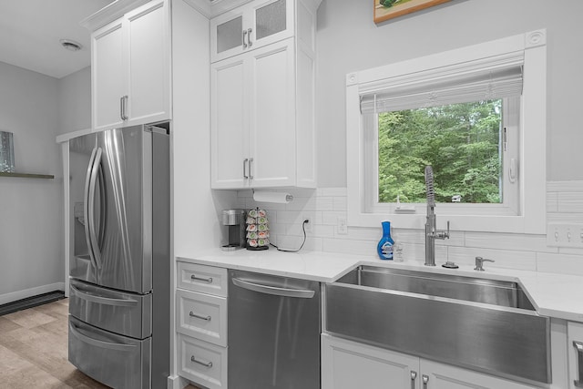 1304 Michillinda Rd, Muskegon, MI 49445 - kitchen featuring stainless steel appliances, a sink, backsplash, and glass insert cabinets