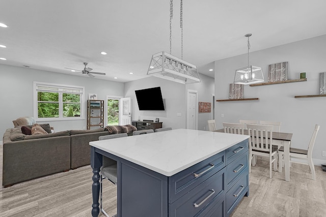 1304 Michillinda Rd, Muskegon, MI 49445 - kitchen with recessed lighting, light wood-type flooring, ceiling fan, blue cabinetry, and a center island