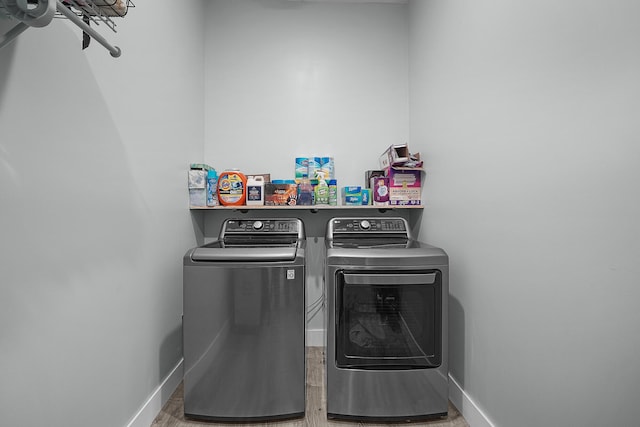 1304 Michillinda Rd, Muskegon, MI 49445 - laundry area with washer and dryer, baseboards, and light wood finished floors