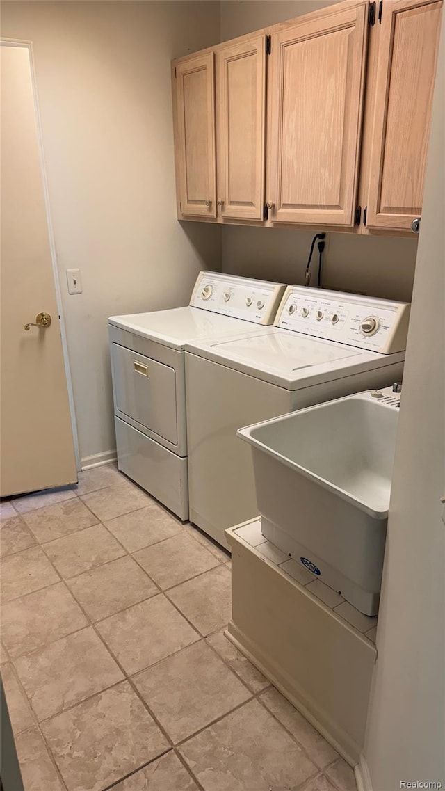 413 Covington Ct Unit 81, Northville, MI 48168 - laundry room featuring washer and clothes dryer, cabinet space, and light tile patterned flooring