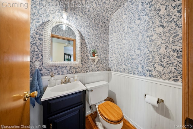 713 Claremont St, Dearborn, MI 48124 - bathroom featuring wallpapered walls, vanity, a wainscoted wall, and wood finished floors