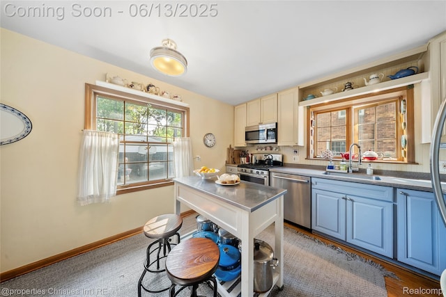 713 Claremont St, Dearborn, MI 48124 - kitchen featuring appliances with stainless steel finishes, blue cabinets, and dark countertops