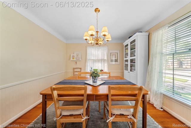 713 Claremont St, Dearborn, MI 48124 - dining room featuring a chandelier, plenty of natural light, light wood-style floors, and a wainscoted wall