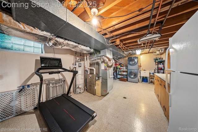 713 Claremont St, Dearborn, MI 48124 - exercise room featuring stacked washer and clothes dryer, gas water heater, and heating unit