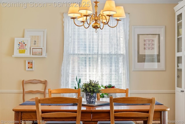 713 Claremont St, Dearborn, MI 48124 - dining area featuring a chandelier and a wainscoted wall