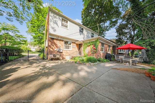713 Claremont St, Dearborn, MI 48124 - back of property featuring brick siding and a patio