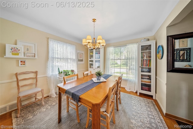 713 Claremont St, Dearborn, MI 48124 - dining space featuring a chandelier and wood finished floors
