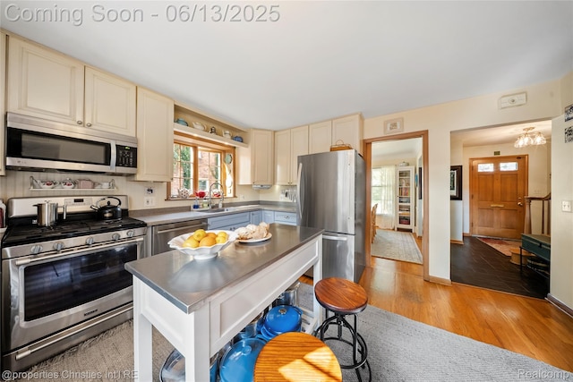 713 Claremont St, Dearborn, MI 48124 - kitchen featuring stainless steel appliances, cream cabinetry, plenty of natural light, and light wood-style floors