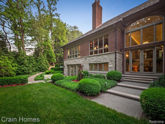 20 Hidden Rdg, Bloomfield Hills, MI 48304 - rear view of house featuring a chimney, french doors, stone siding, and a yard