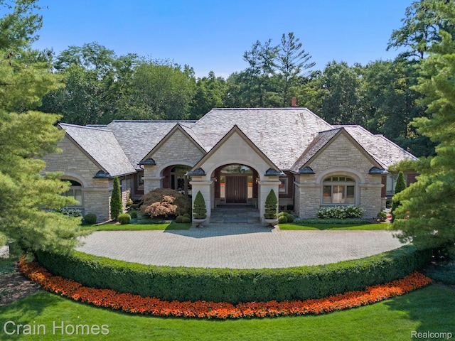 20 Hidden Rdg, Bloomfield Hills, MI 48304 - french provincial home featuring stone siding, a high end roof, and a front yard