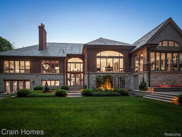 20 Hidden Rdg, Bloomfield Hills, MI 48304 - back of property with a lawn, a chimney, stone siding, and a high end roof