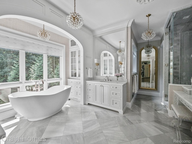 20 Hidden Rdg, Bloomfield Hills, MI 48304 - full bathroom featuring a chandelier, vanity, a freestanding bath, crown molding, and a stall shower