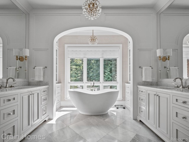20 Hidden Rdg, Bloomfield Hills, MI 48304 - full bathroom with a chandelier, two vanities, and a freestanding tub