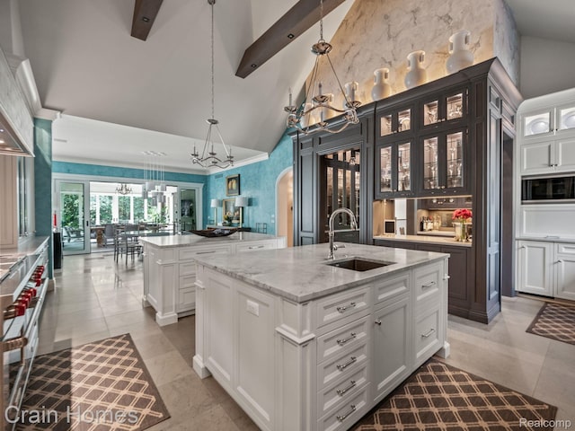 20 Hidden Rdg, Bloomfield Hills, MI 48304 - kitchen featuring a sink, an island with sink, a chandelier, arched walkways, and high vaulted ceiling