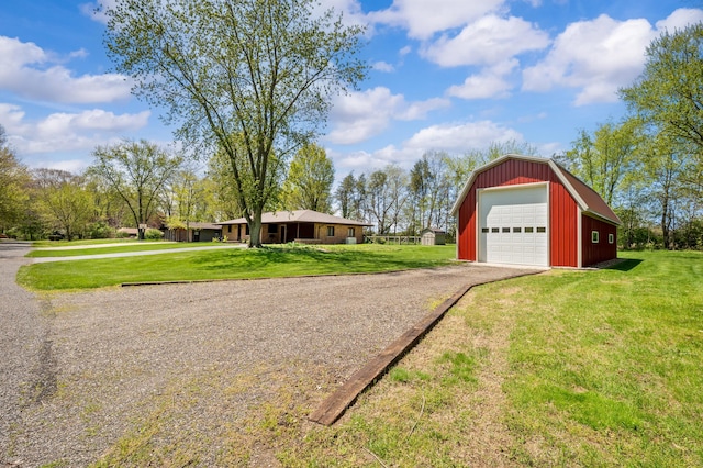 2794 W Park Ln, Benton Harbor, MI 49022 - view of side of home with dirt driveway, an outdoor structure, a garage, and a yard