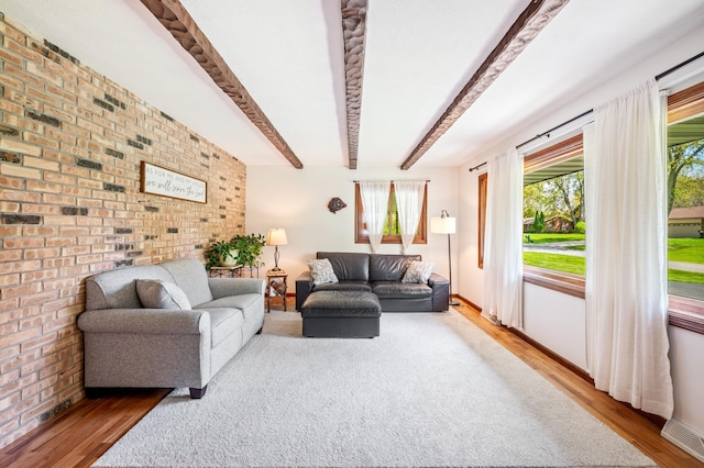 2794 W Park Ln, Benton Harbor, MI 49022 - living room featuring wood finished floors, brick wall, healthy amount of natural light, and beamed ceiling