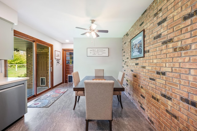 2794 W Park Ln, Benton Harbor, MI 49022 - dining room featuring brick wall, a ceiling fan, and an accent wall