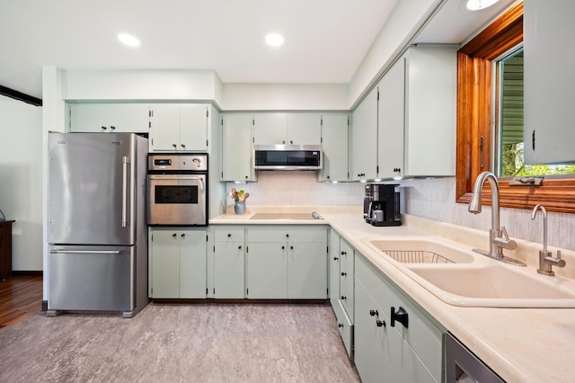 2794 W Park Ln, Benton Harbor, MI 49022 - kitchen with appliances with stainless steel finishes, a sink, tasteful backsplash, light countertops, and recessed lighting