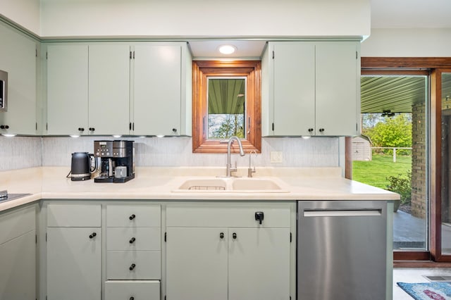 2794 W Park Ln, Benton Harbor, MI 49022 - kitchen featuring stainless steel dishwasher, a sink, light countertops, and tasteful backsplash