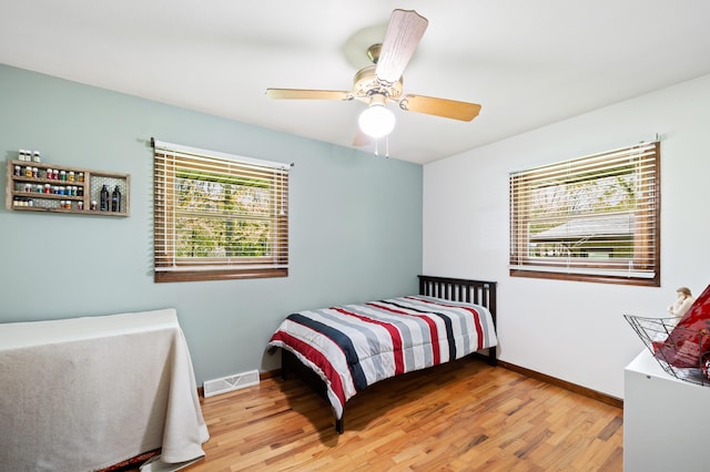2794 W Park Ln, Benton Harbor, MI 49022 - bedroom with wood finished floors, baseboards, and ceiling fan