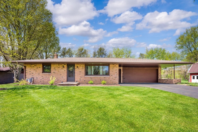2794 W Park Ln, Benton Harbor, MI 49022 - view of front facade featuring brick siding, a garage, and driveway