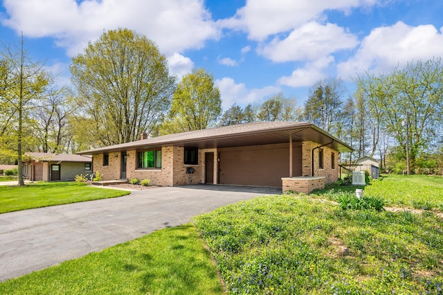 2794 W Park Ln, Benton Harbor, MI 49022 - single story home with driveway, brick siding, a front yard, and an attached carport