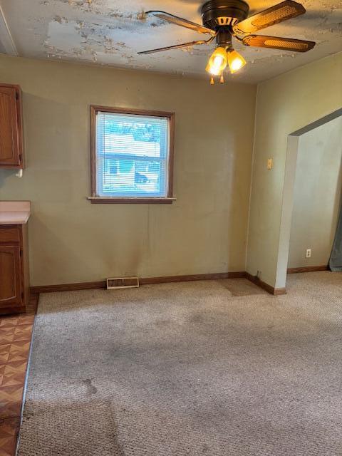 408 Hill St, Buchanan, MI 49107 - empty room with a ceiling fan, baseboards, and light colored carpet