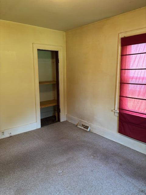 408 Hill St, Buchanan, MI 49107 - empty room with dark carpet and baseboards
