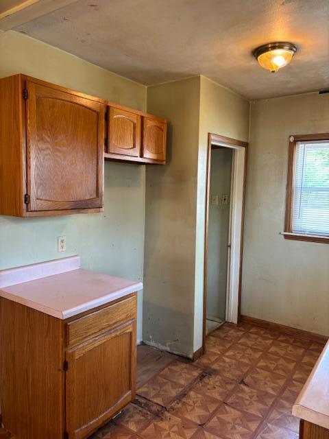 408 Hill St, Buchanan, MI 49107 - kitchen featuring light countertops, brown cabinets, and baseboards