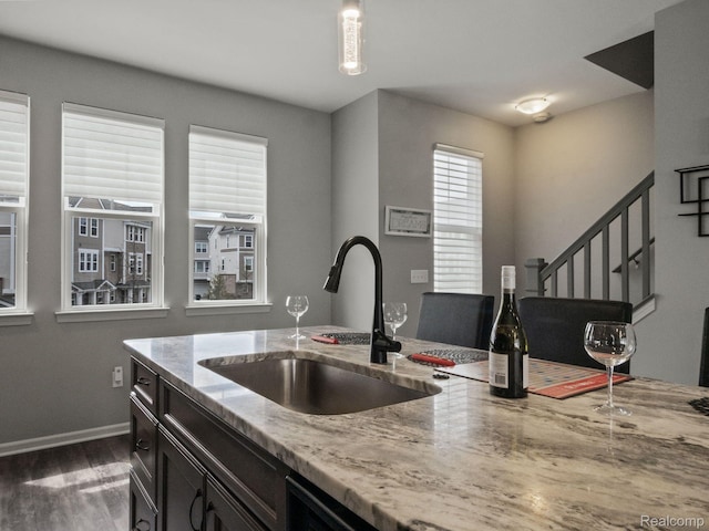 2500 Normandy Rd Unit 41, Royal Oak, MI 48073 - kitchen featuring a sink, light stone counters, dark wood finished floors, and baseboards