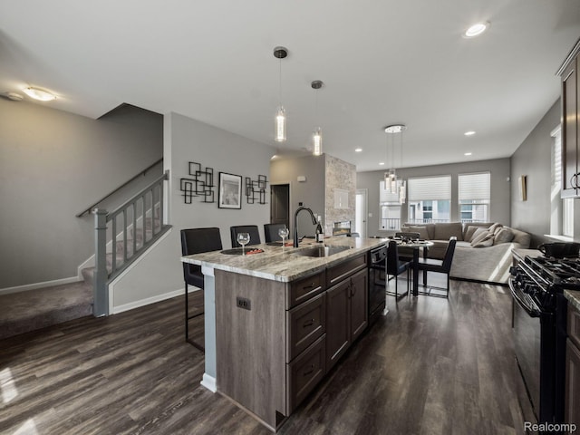 2500 Normandy Rd Unit 41, Royal Oak, MI 48073 - kitchen with a sink, black appliances, a kitchen breakfast bar, open floor plan, and dark wood finished floors