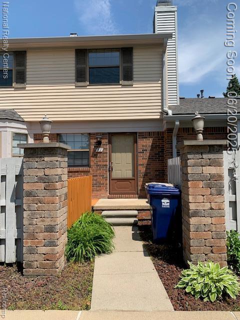 2041 N Arbor Way Dr Unit 71, Canton, MI 48188 - view of front of property featuring a chimney and brick siding