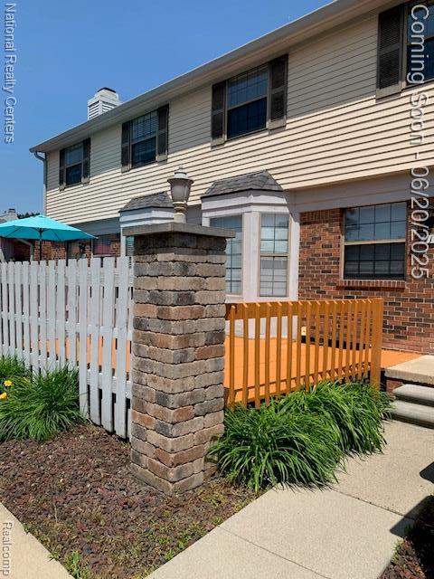 2041 N Arbor Way Dr Unit 71, Canton, MI 48188 - view of front of house with brick siding and a chimney