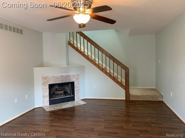 2041 N Arbor Way Dr Unit 71, Canton, MI 48188 - unfurnished living room featuring ceiling fan, wood finished floors, stairs, and a tiled fireplace