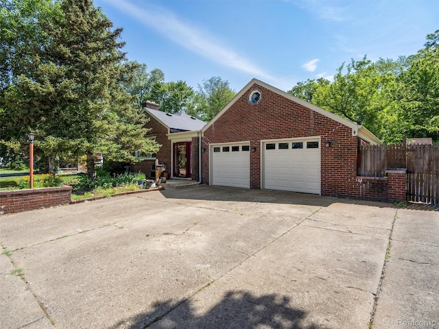 28212 Shock St, Saint Clair Shores, MI 48081 - view of front of property with driveway, an attached garage, and brick siding