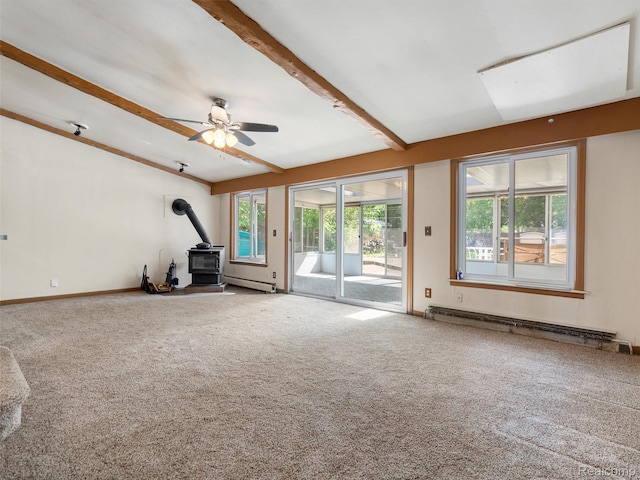 28212 Shock St, Saint Clair Shores, MI 48081 - unfurnished living room featuring a wood stove, baseboard heating, carpet floors, ceiling fan, and a baseboard radiator