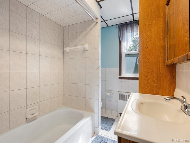 28212 Shock St, Saint Clair Shores, MI 48081 - full bathroom featuring radiator, tile walls, tile patterned floors, vanity, and bathing tub / shower combination