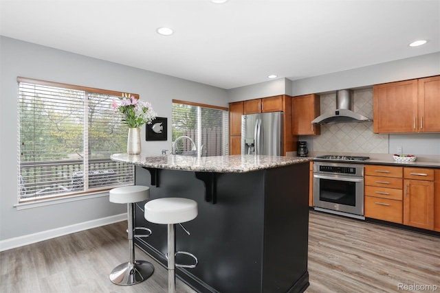 6532 Turtle Walk, Clarkston, MI 48346 - kitchen featuring wall chimney exhaust hood, stainless steel appliances, a kitchen breakfast bar, light wood finished floors, and recessed lighting