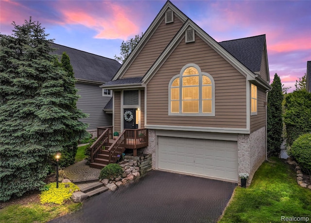 6532 Turtle Walk, Clarkston, MI 48346 - view of front facade with an attached garage, driveway, roof with shingles, and brick siding