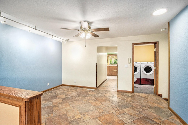 14894 L Dr N, Marshall, MI 49068 - spare room with washing machine and clothes dryer, a ceiling fan, baseboards, light stone finish floors, and a textured ceiling