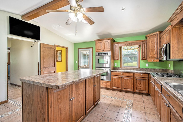 14894 L Dr N, Marshall, MI 49068 - kitchen with stainless steel appliances, light tile patterned floors, a kitchen island, lofted ceiling, and brown cabinetry