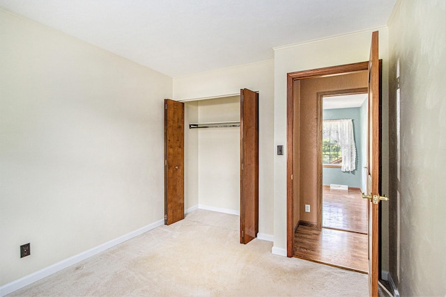 14894 L Dr N, Marshall, MI 49068 - unfurnished bedroom featuring light carpet, a closet, and baseboards