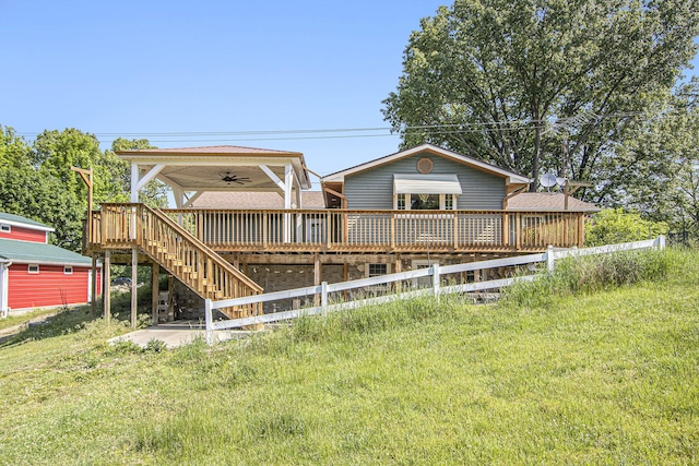 14894 L Dr N, Marshall, MI 49068 - back of property with a ceiling fan, a wooden deck, stairway, and a yard